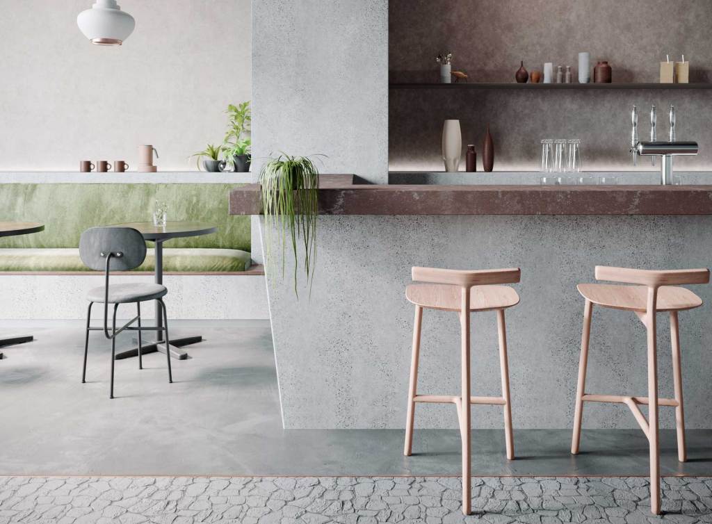 Zu sehen ist ein großer Raum mit einer Bar eingerichtet und Barhockern davor. Sämtliche Flächen wurden durch Dekorfolien verklebt in verschiedenen Designs