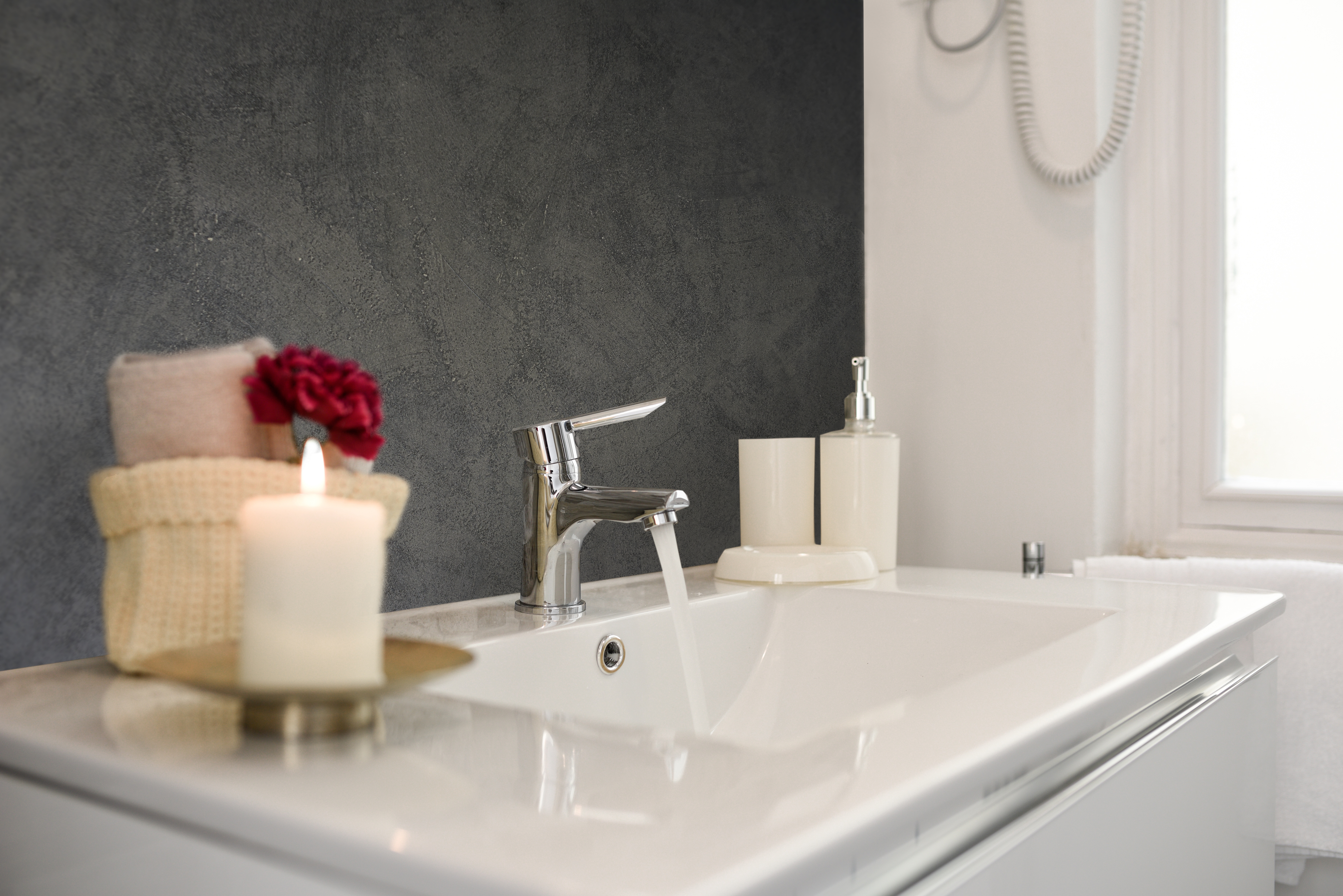 A bathroom with a white sink and a wall wrapped in Imageperfect refresh obsidian stone film