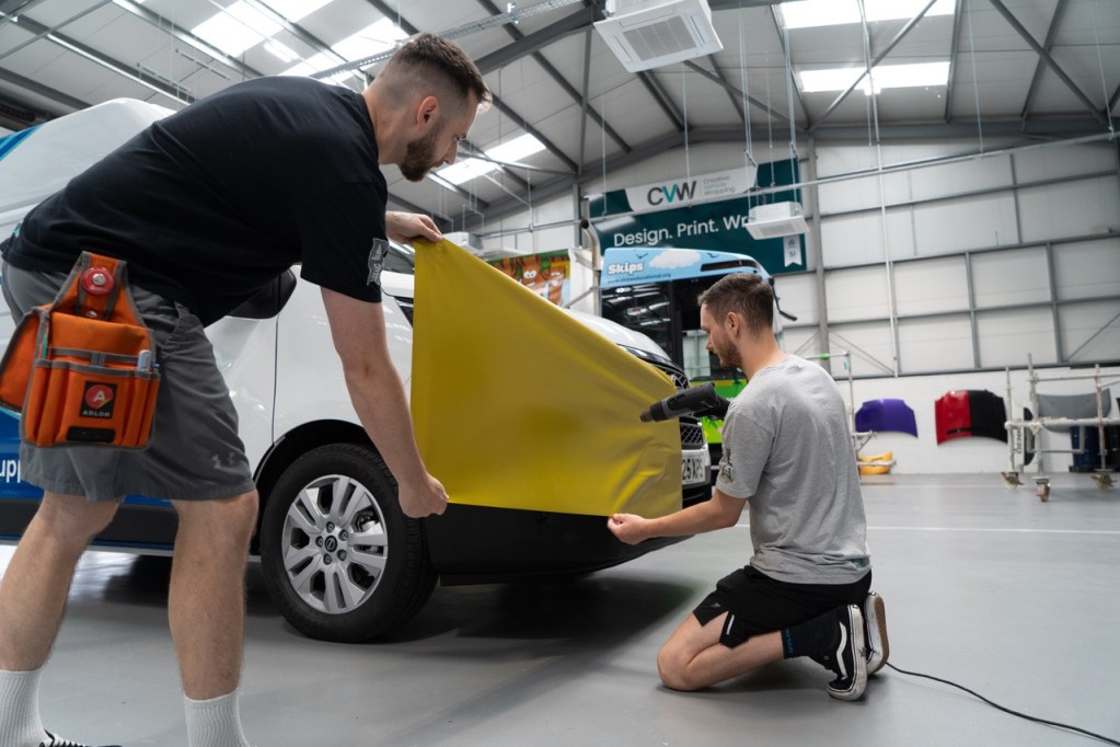 The team of Creative Vehicle Wrapping while installing wrap film.